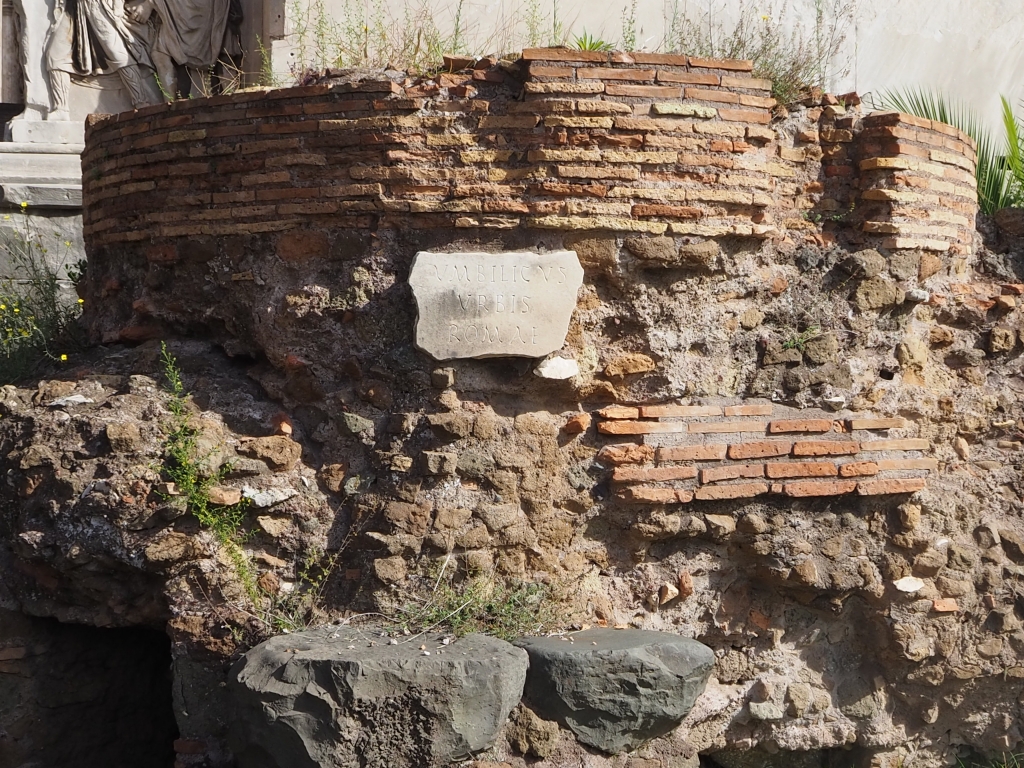 The navel of Rome can almost be missed amidst the Roman Forum